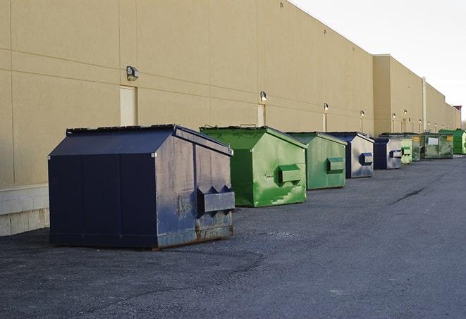 a group of construction workers taking a break near a dumpster in Central City